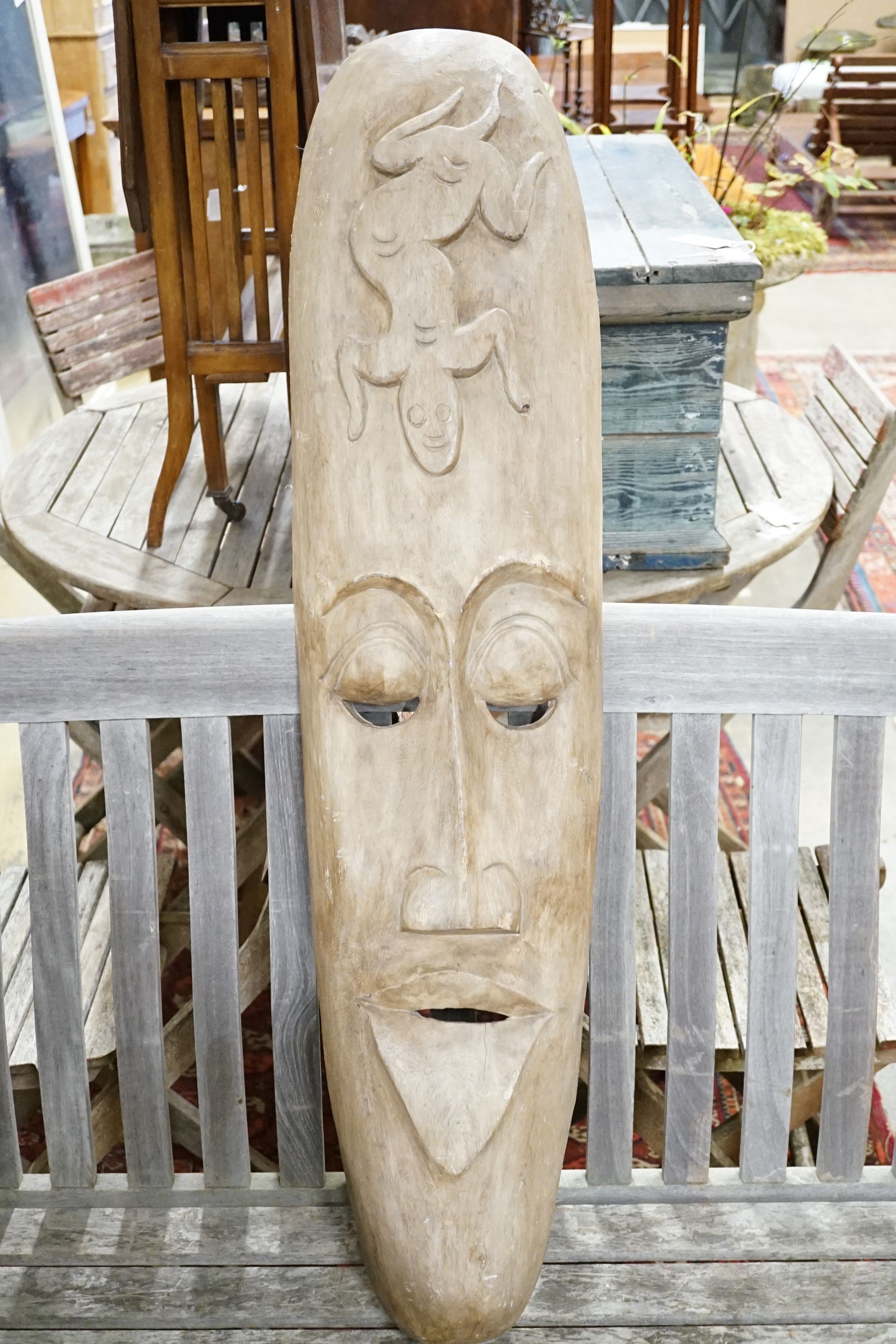 A Polynesian style carved wood mask, height 110cm